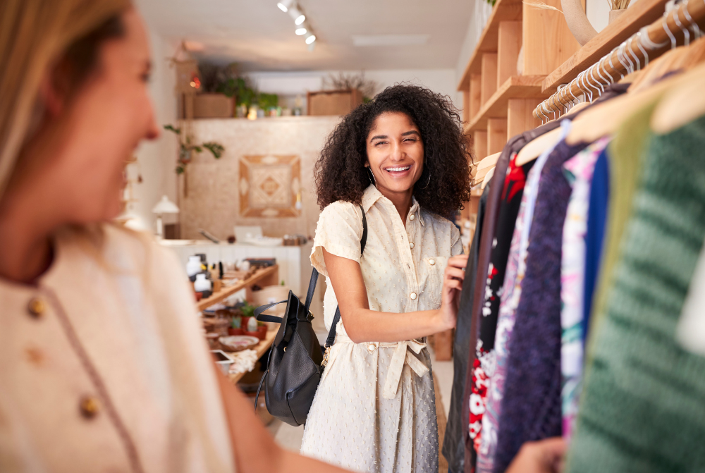 Two women shopping at a store together. They are smiling because AI ensured proper inventory allocation.