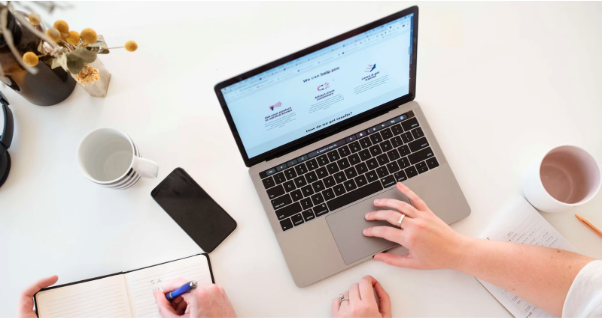 Modern workspace with MacBook Pro, iPhone and notebook