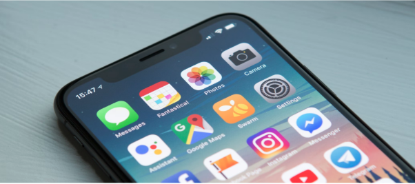 iPhone X screen with many different app icons visible