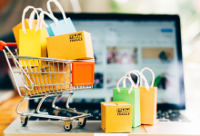 Shopping cart filled with items next to computer. Showing relationship between AI and shopping