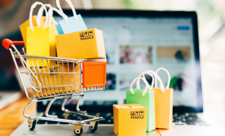 Shopping cart filled with items next to computer. Showing relationship between AI and shopping