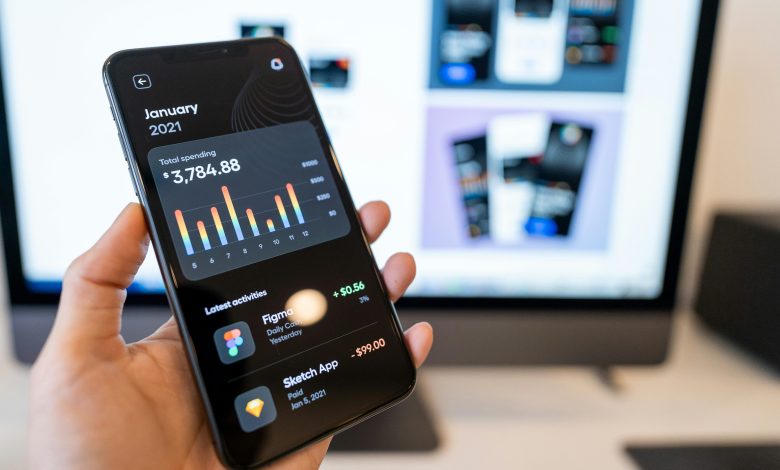 Phone displaying a personal spending app with latest activities using ai for credit analysis.